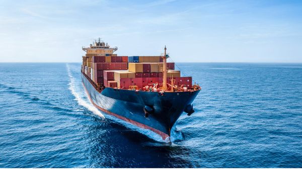 Loaded container ship sailing across open ocean water