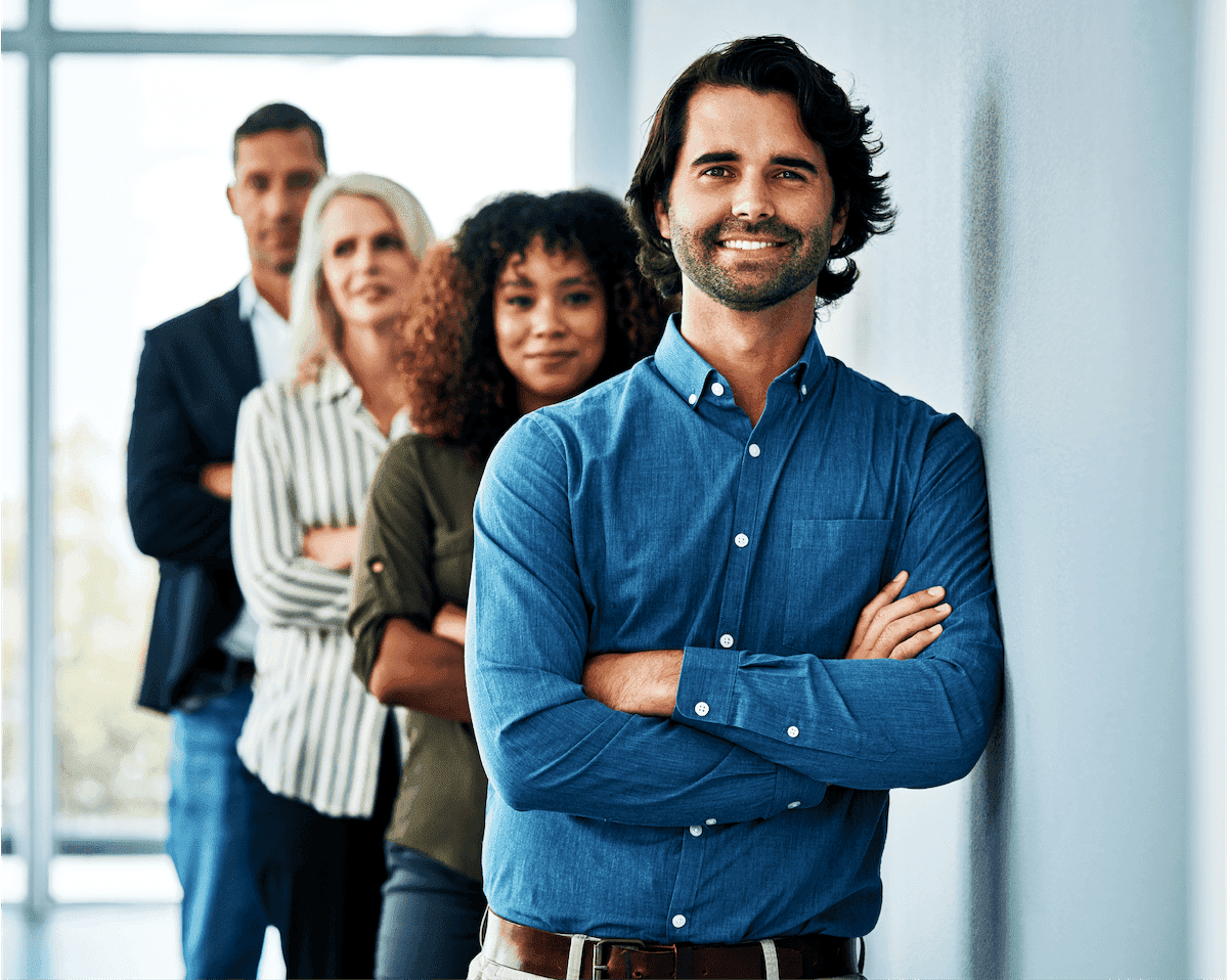 A diverse group of five professionals standing confidently in an office