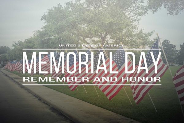 Rows of American flags line a misty grass area under a tree, with "Memorial Day: Remember and Honor" text overlay