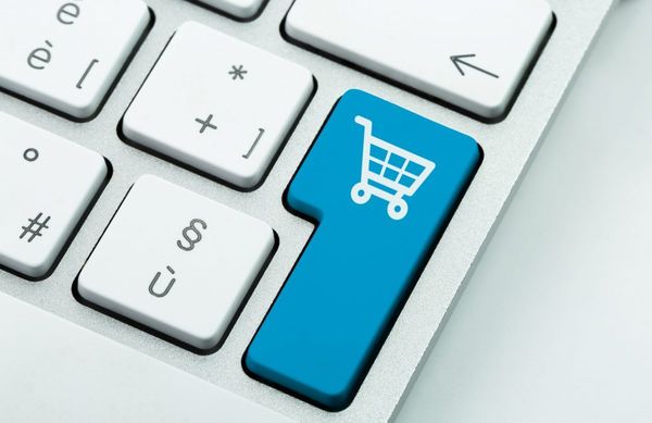 Blue keyboard key with a white shopping cart icon, symbolizing online shopping or e-commerce