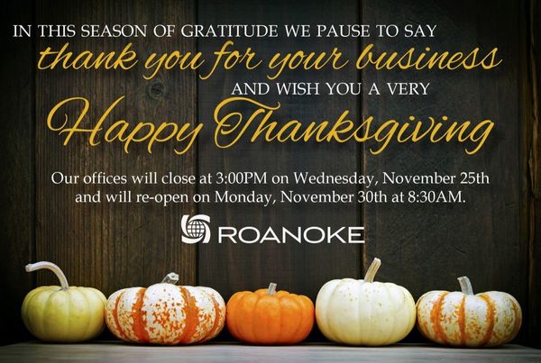 Nksgiving greeting from Roanoke with six variegated pumpkins against dark wood, announcing holiday office hours