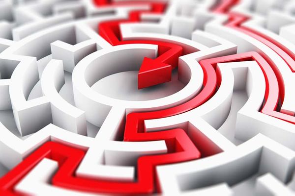 Bright red path cutting through a white circular maze, highlighting a successful navigation route to the center