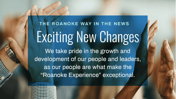 Hands holding a blue sign about "Exciting New Changes" at Roanoke, emphasizing people and leadership development