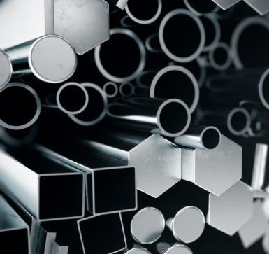 Metallic geometric shapes including round tubes, hexagonal forms, and square pipes arranged in a monochromatic